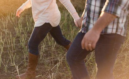 two person wearing denim pants on grass field